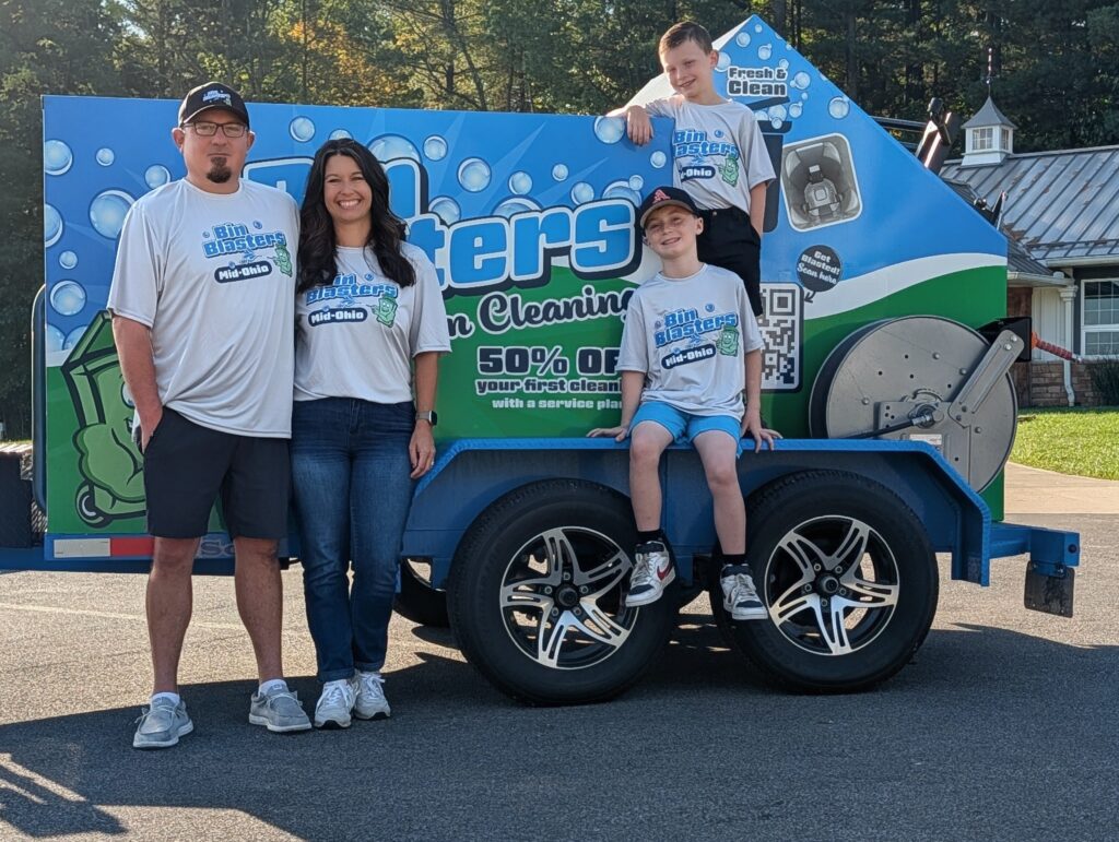 PXL_20250928_132947127~2 Jason and Carrie Gough, family owned, standing in front of trailer